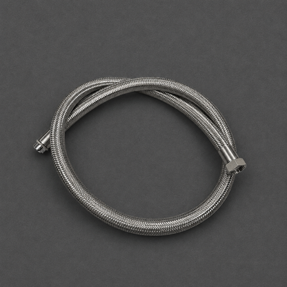 A coiled stainless steel braided hose with metal fittings, photographed on a dark gray background.
