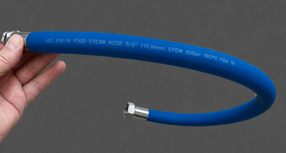 A blue flexible steam hose with silver metal connectors, held by a hand against a dark gray background.